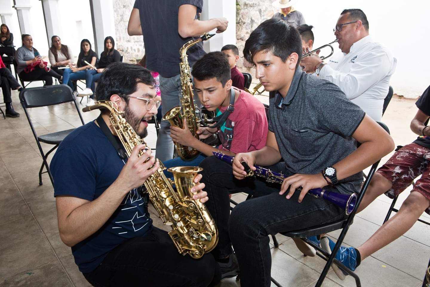 Alan Helping a Student with their instrument